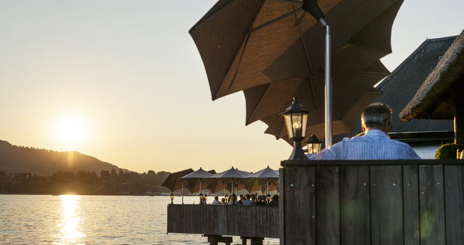 Sunset view from Fischerstube's lakeside terrace on Lake Zurich.