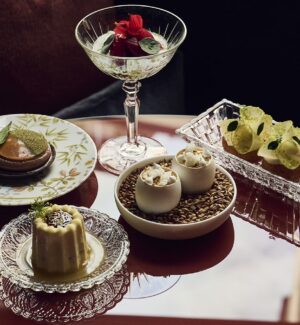 Selection of sharing dishes and a cocktail at IGNIV Zurich by chef Andreas Caminada.