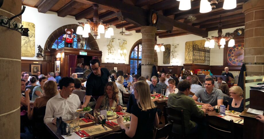 Bustling dining room inside Zeughauskeller in Zurich.