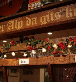 Warm timber-panelled interior of &Auml;lpli Bar in Zurich, with wooden tables and traditional d&eacute;cor.
